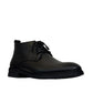 Atropat Ferdowsi black genuine leather chukka boots with handmade stitching and rubber outsole. Photo of front view at an angle.