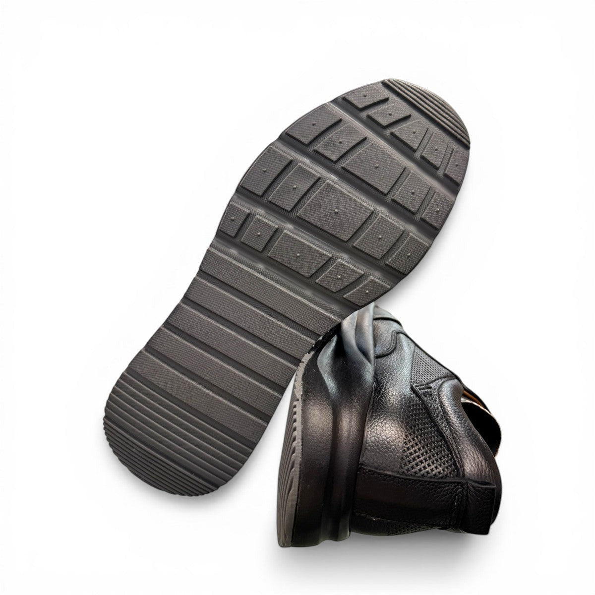 Atropat Kaya black leather slip-on shoes with textured upper and durable rubber sole. Photo of bottom view.