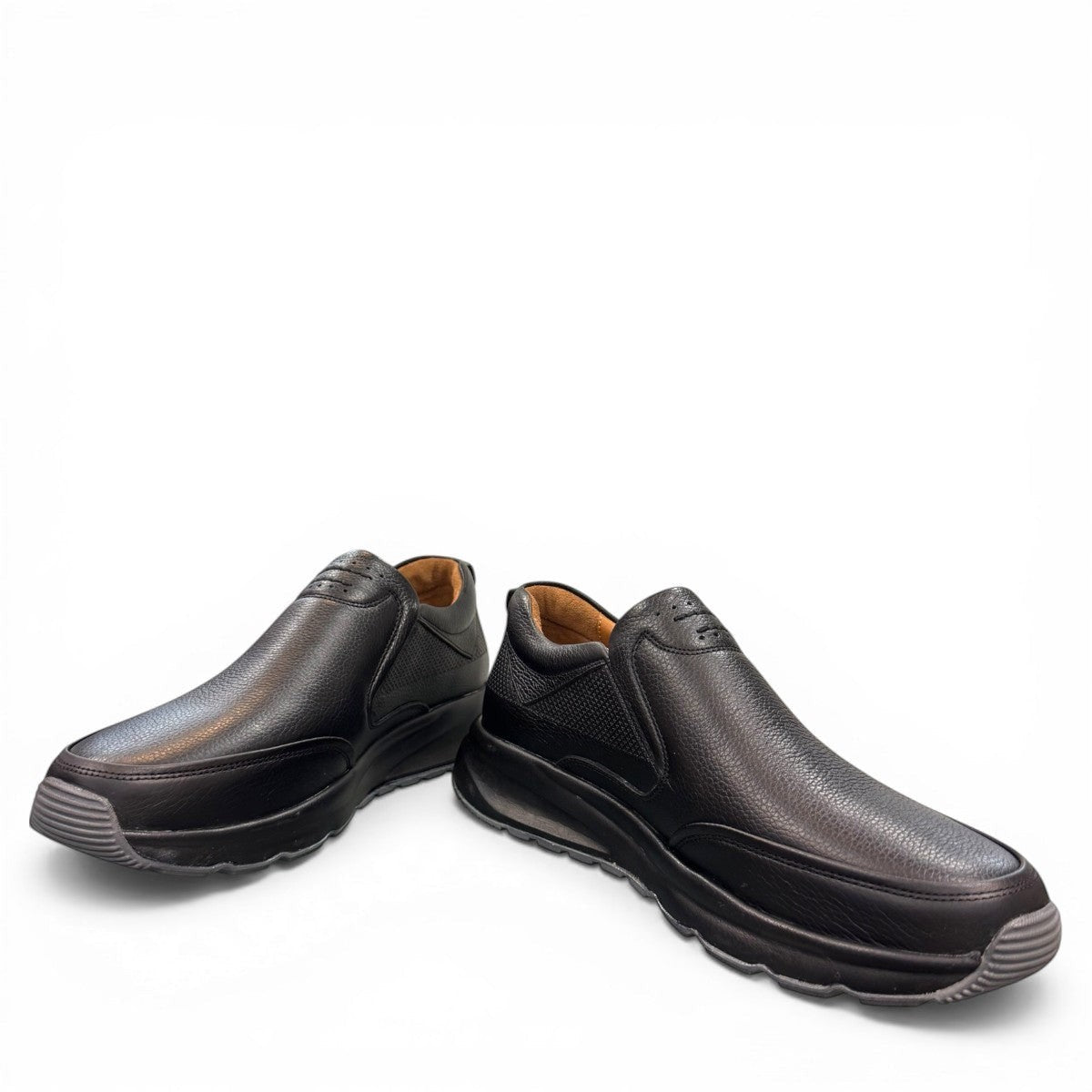 Atropat Kaya black leather slip-on shoes with textured upper and durable rubber sole. Photo of front view at an angle.
