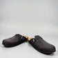 Biotime Burly black leather clogs showing the textured EVA outsole and cork footbed from below.