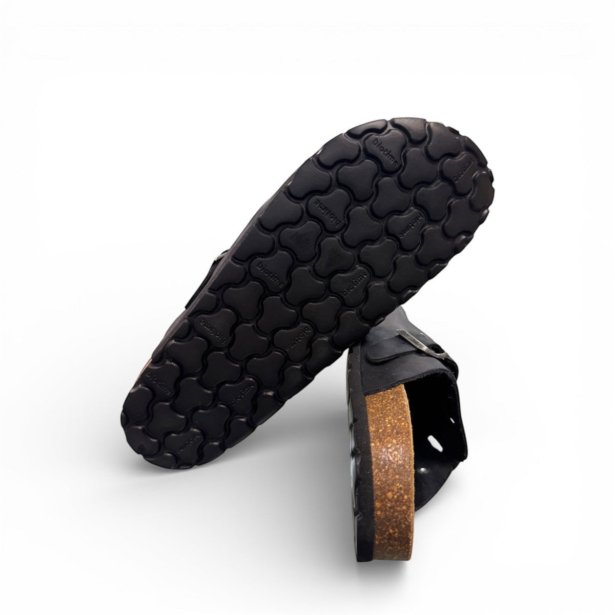 Biotime Burly black leather clogs showing the textured EVA outsole and cork footbed from below.