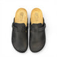 Biotime Burly black leather clogs showing the textured EVA outsole and cork footbed from below.