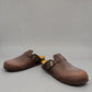 Biotime Burly dark brown oiled leather clogs showing the patterned EVA outsole and cork footbed.