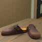 Biotime Burly dark brown oiled leather clogs showing the patterned EVA outsole and cork footbed.