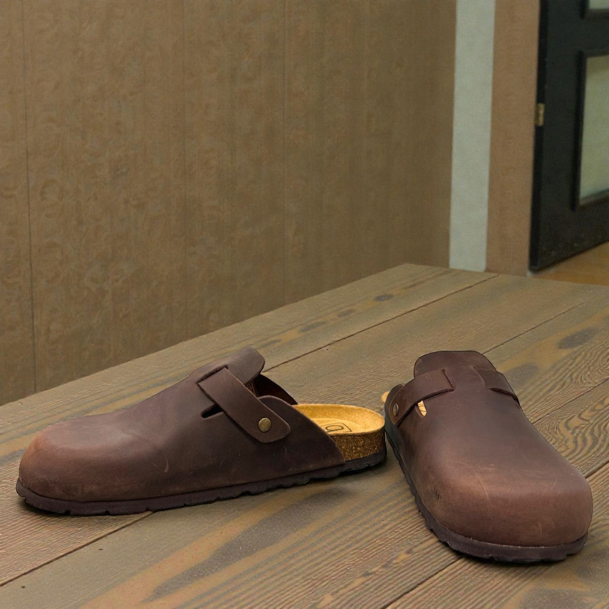 Biotime Burly dark brown oiled leather clogs showing the patterned EVA outsole and cork footbed.