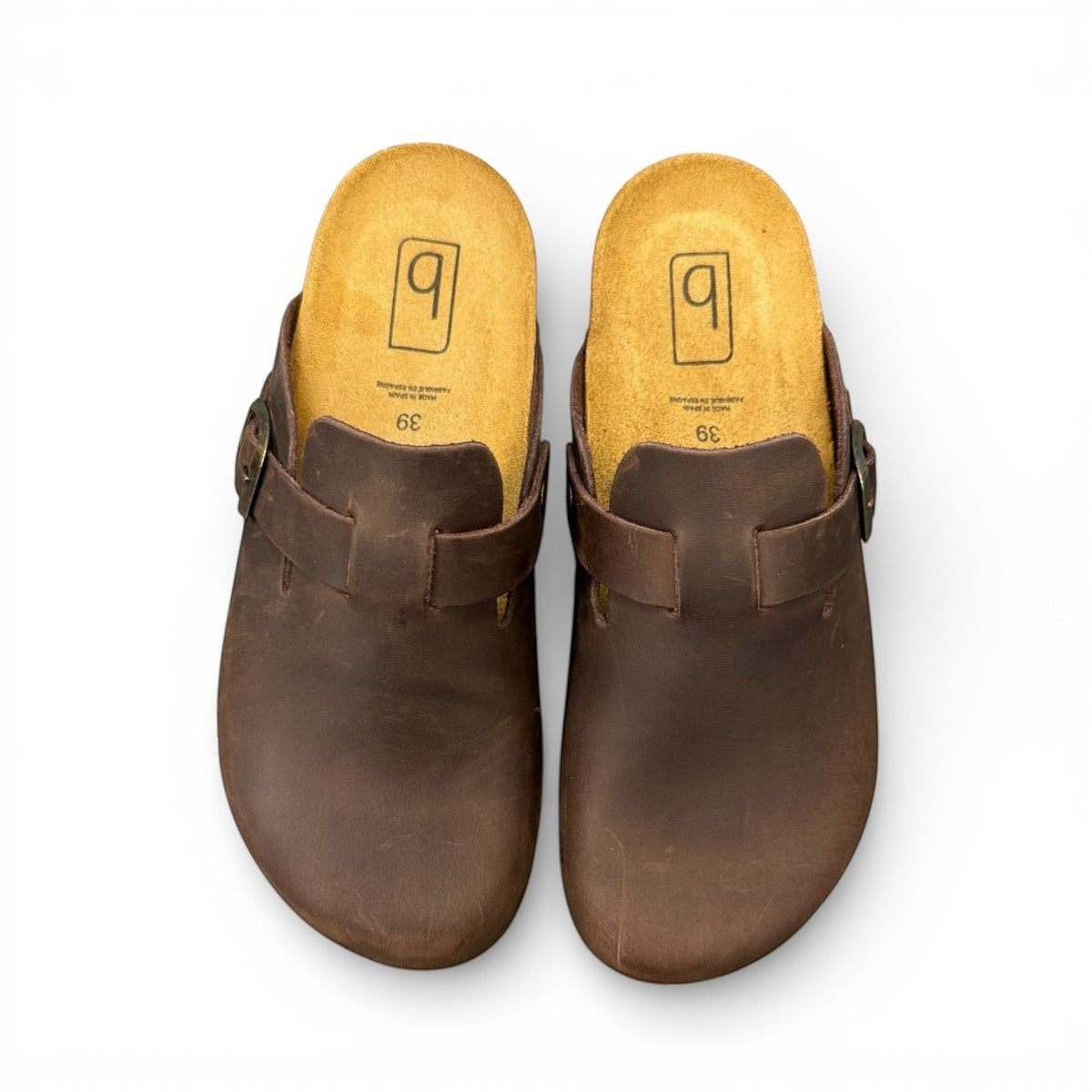 Biotime Burly dark brown oiled leather clogs showing the patterned EVA outsole and cork footbed.