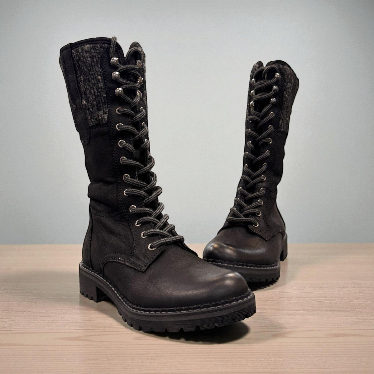 Biotime Taya black leather tall lace-up boots with a warm wool lining and durable lug sole.