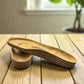 authentic Birkenstock cork footbed replacement for sandal repair service on a wooden table