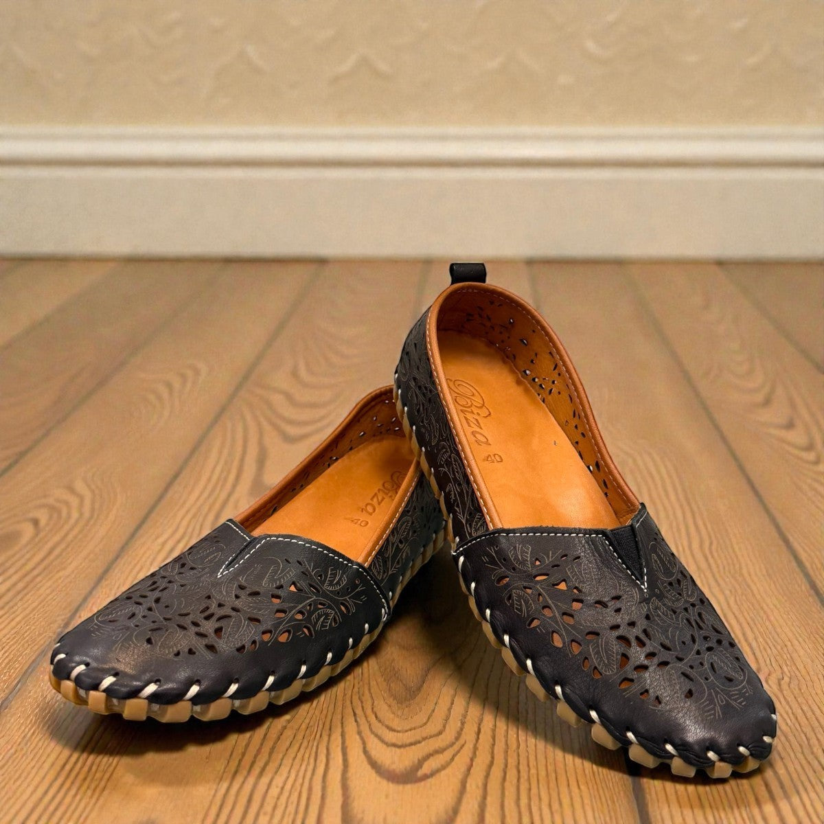 Biza Sophie black leather slip-on loafer with laser cut floral detailing and handstitched moccasin sole
