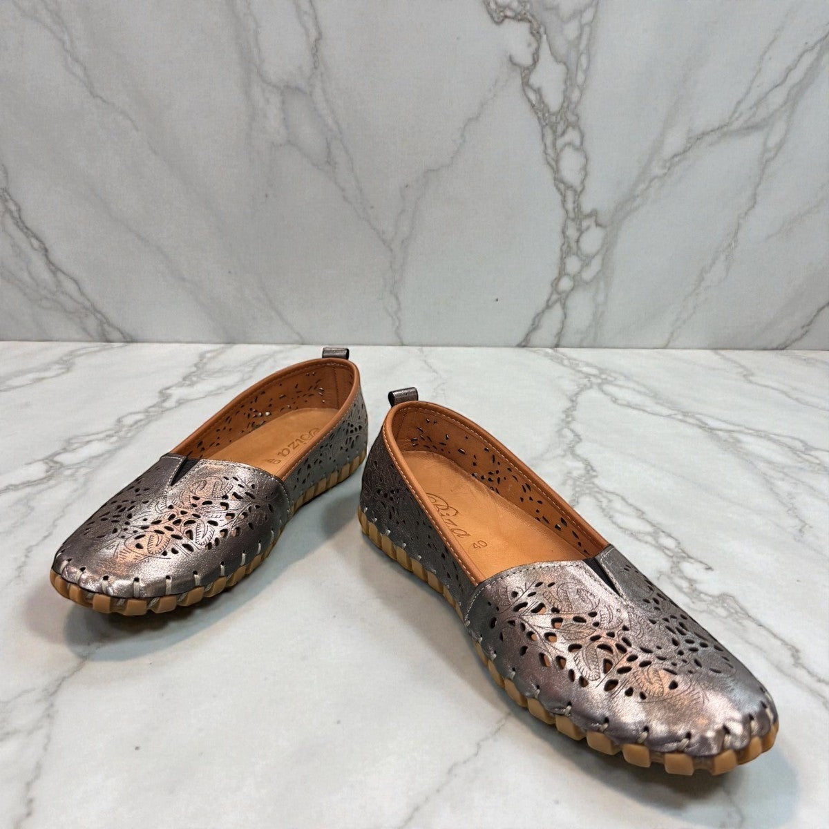 Biza Sophie pewter leather slip-on loafer with laser-cut floral detailing and handstitched construction.
