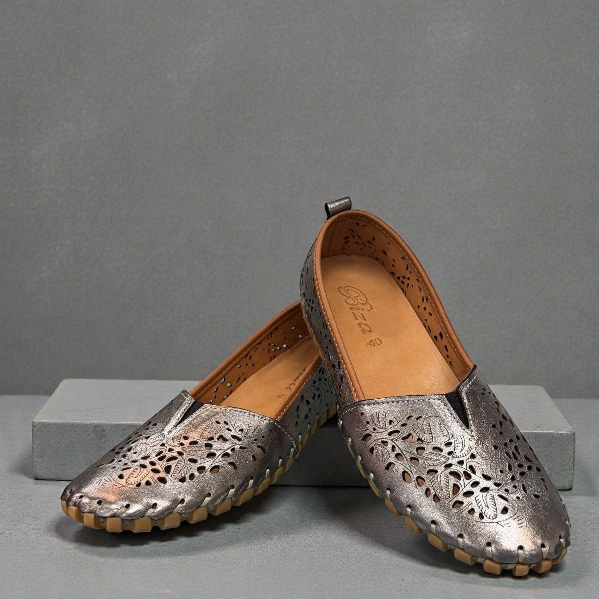 Biza Sophie pewter leather slip-on loafer with laser-cut floral detailing and handstitched construction.