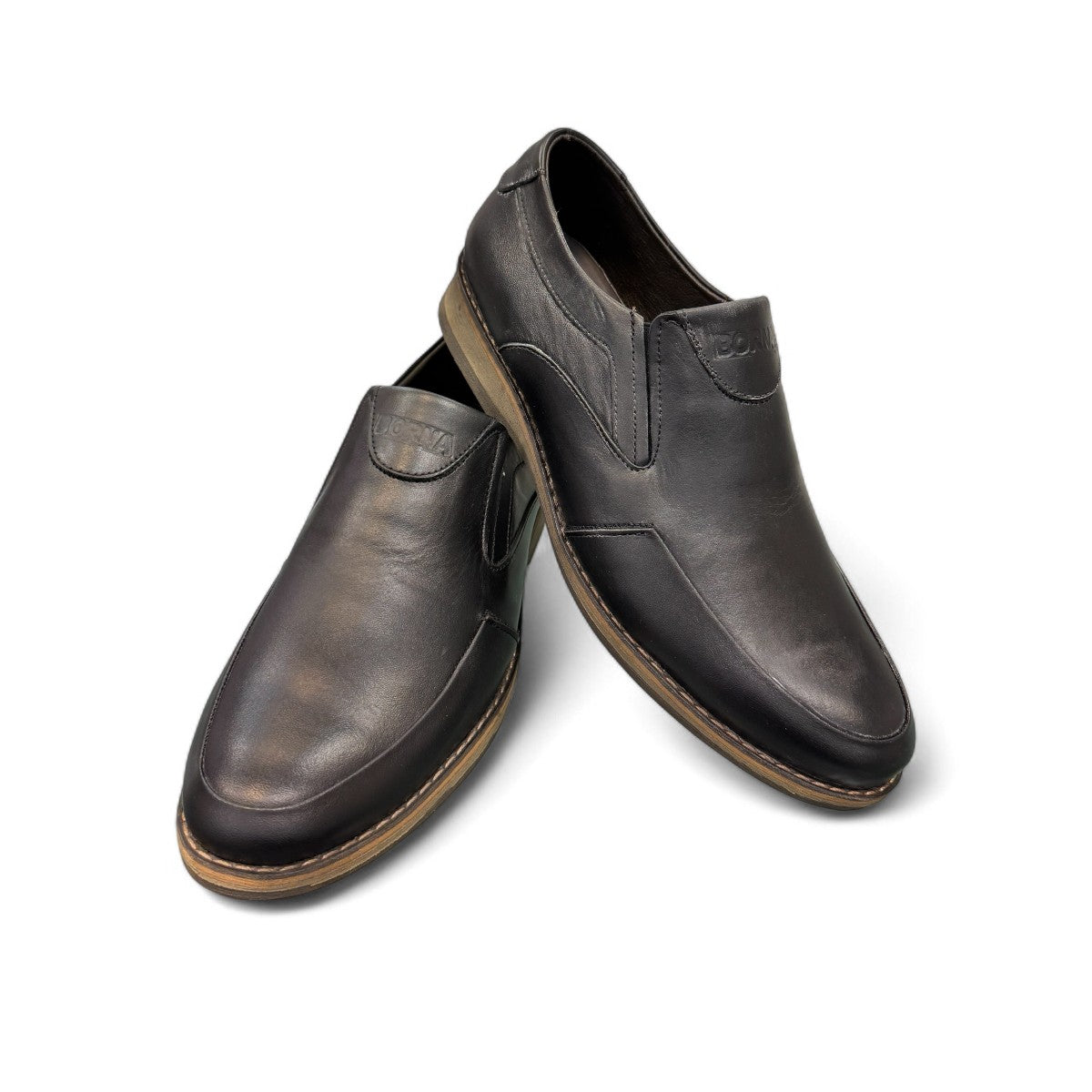 Borna Sadabad black leather slip-on men's shoes with a durable rubber outsole and minimalist design. Photo of front side view.