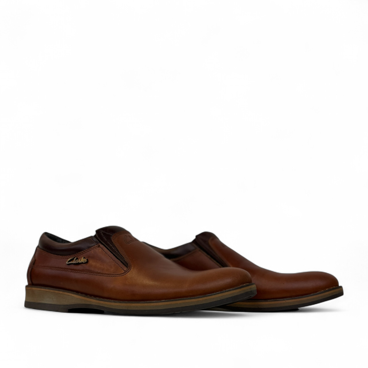 Borna Shams brown leather slip-on men's shoes with a rubber outsole and side branding detail. Photo of side views.