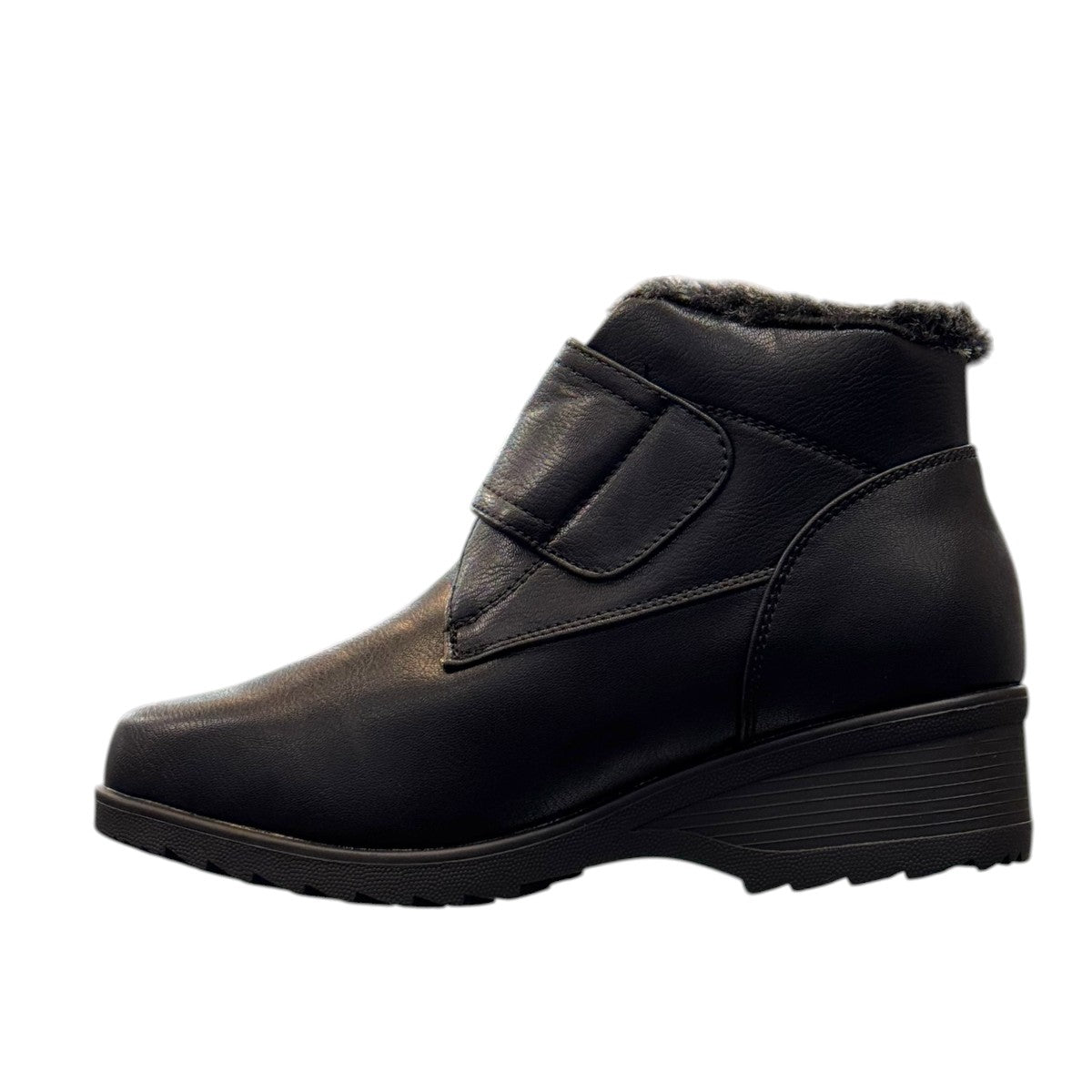 Canada Comfort black waterproof ankle boot with velcro strap and faux fur trim for winter traction. Photo of left side view.