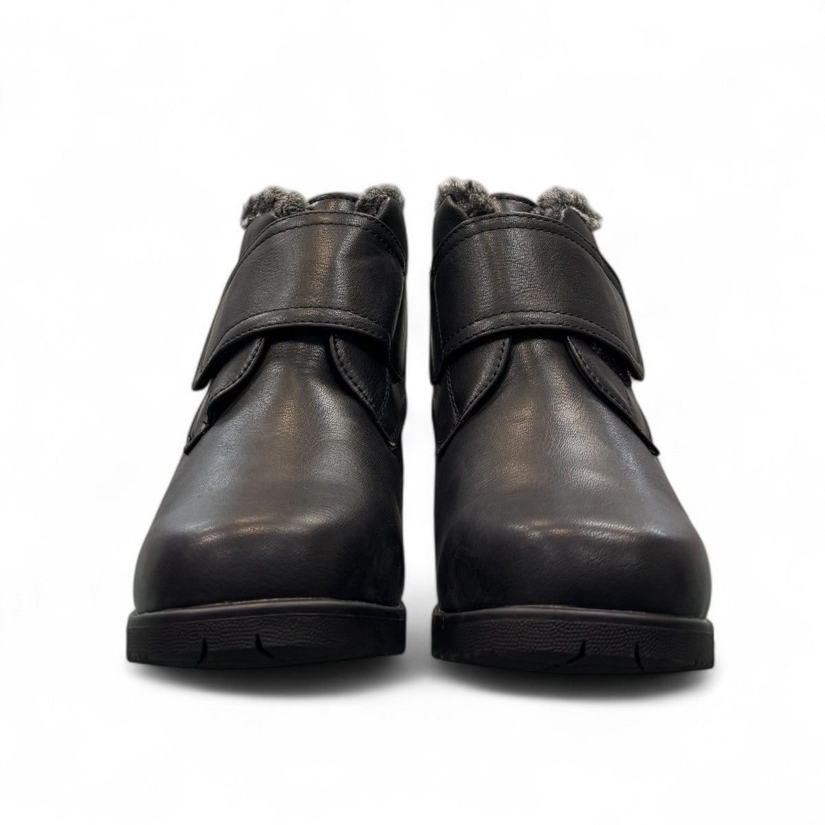 Canada Comfort black waterproof ankle boot with velcro strap and faux fur trim for winter traction. Photo of front view.