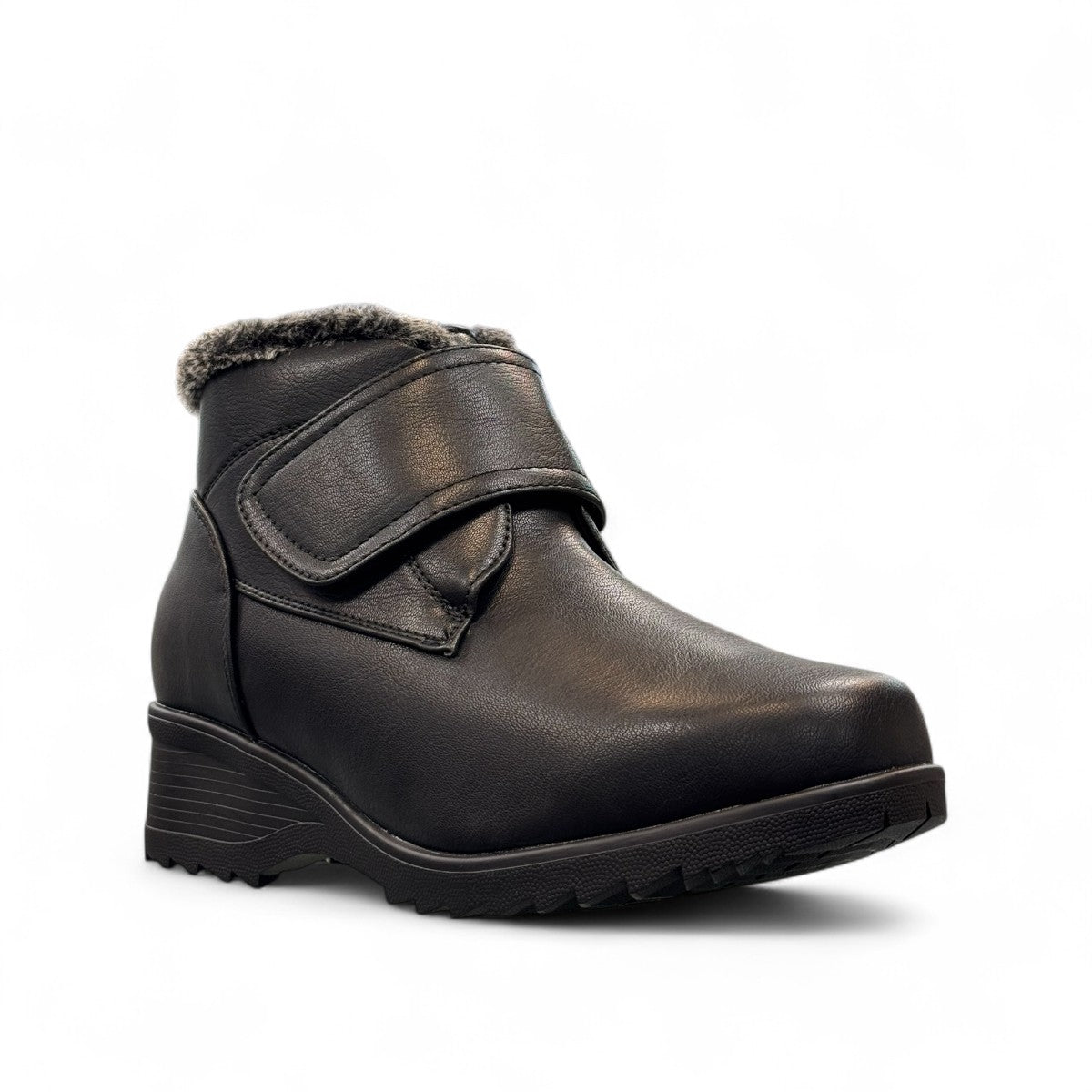 Canada Comfort black waterproof ankle boot with velcro strap and faux fur trim for winter traction. Photo of side view.
