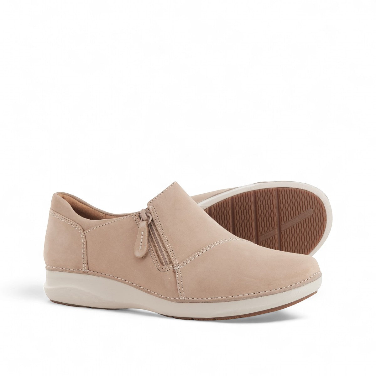 Clarks Appley Zip slip-on shoes in sand nubuck leather with side zipper and cushioned sole. front view.
