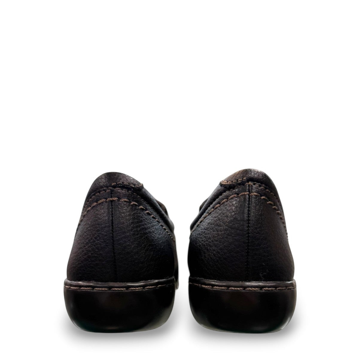 Clarks Ashland Effie black leather slip-on shoe with round toe and decorative button detail. back view