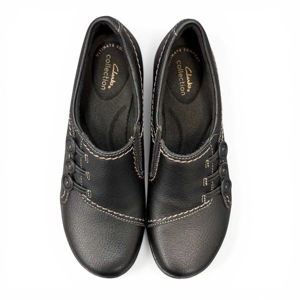 Clarks Ashland Effie black leather slip-on shoe with round toe and decorative button detail. top view.