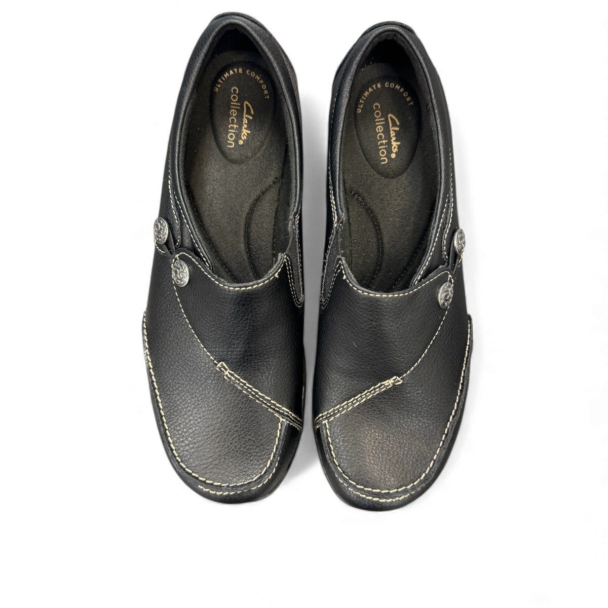Clarks Ashland Lane Q black leather slip-on shoe with decorative buttons and contrast stitching. top view.