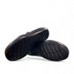 Clarks Ashland Lane Q black leather slip-on shoe with decorative buttons and contrast stitching. bottom view.