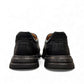 Clarks Un Brawley Step black leather slip-on shoe with textured rubber sole and stitched construction. photo of the back.