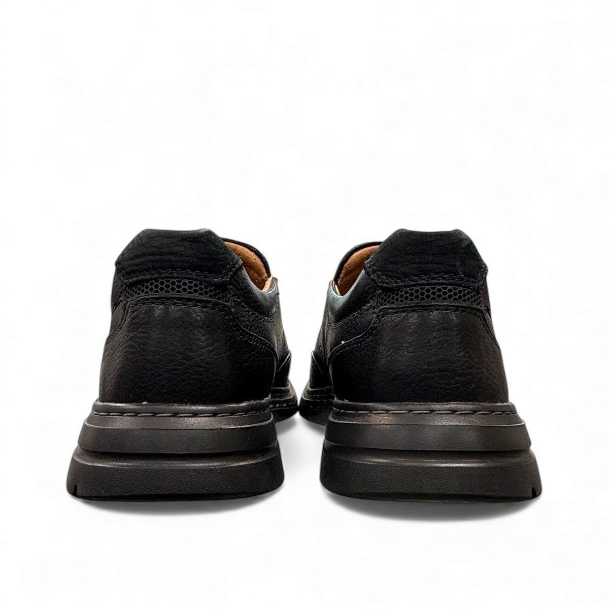 Clarks Un Brawley Step black leather slip-on shoe with textured rubber sole and stitched construction. photo of the back.