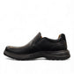 Clarks Un Brawley Step black leather slip-on shoe with textured rubber sole and stitched construction. photo of the left side.