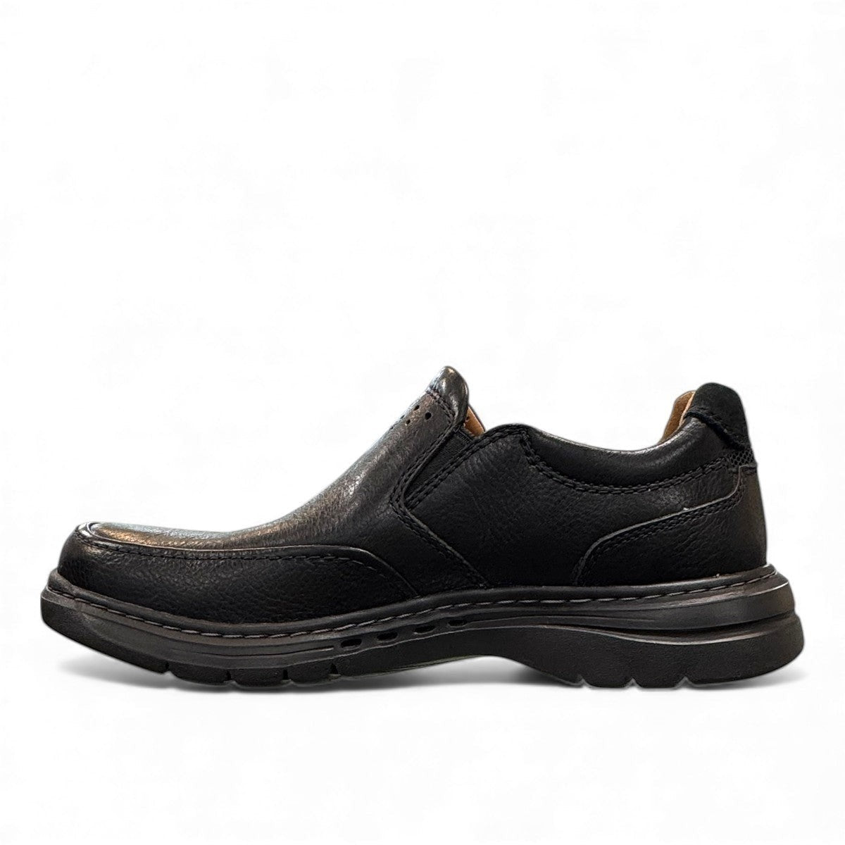 Clarks Un Brawley Step black leather slip-on shoe with textured rubber sole and stitched construction. photo of the left side.