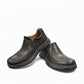 Clarks Un Brawley Step black leather slip-on shoe with textured rubber sole and stitched construction. photo of the front.