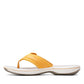 Clarks Breeze Sea flip-flops in burnt yellow with a lightweight sole and adjustable strap closure. left view.