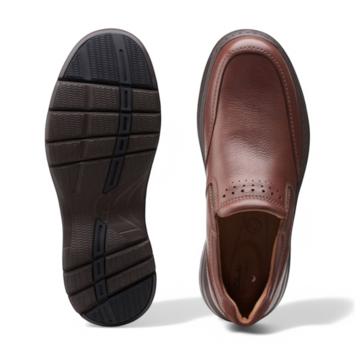Clarks Un Brawley Step brown leather slip-on shoe with a rounded toe and textured rubber sole. photo of the top.