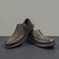 Clarks Cotrell Step men's slip-on shoe in black oily leather with a shock-absorbing rubber outsole. front view