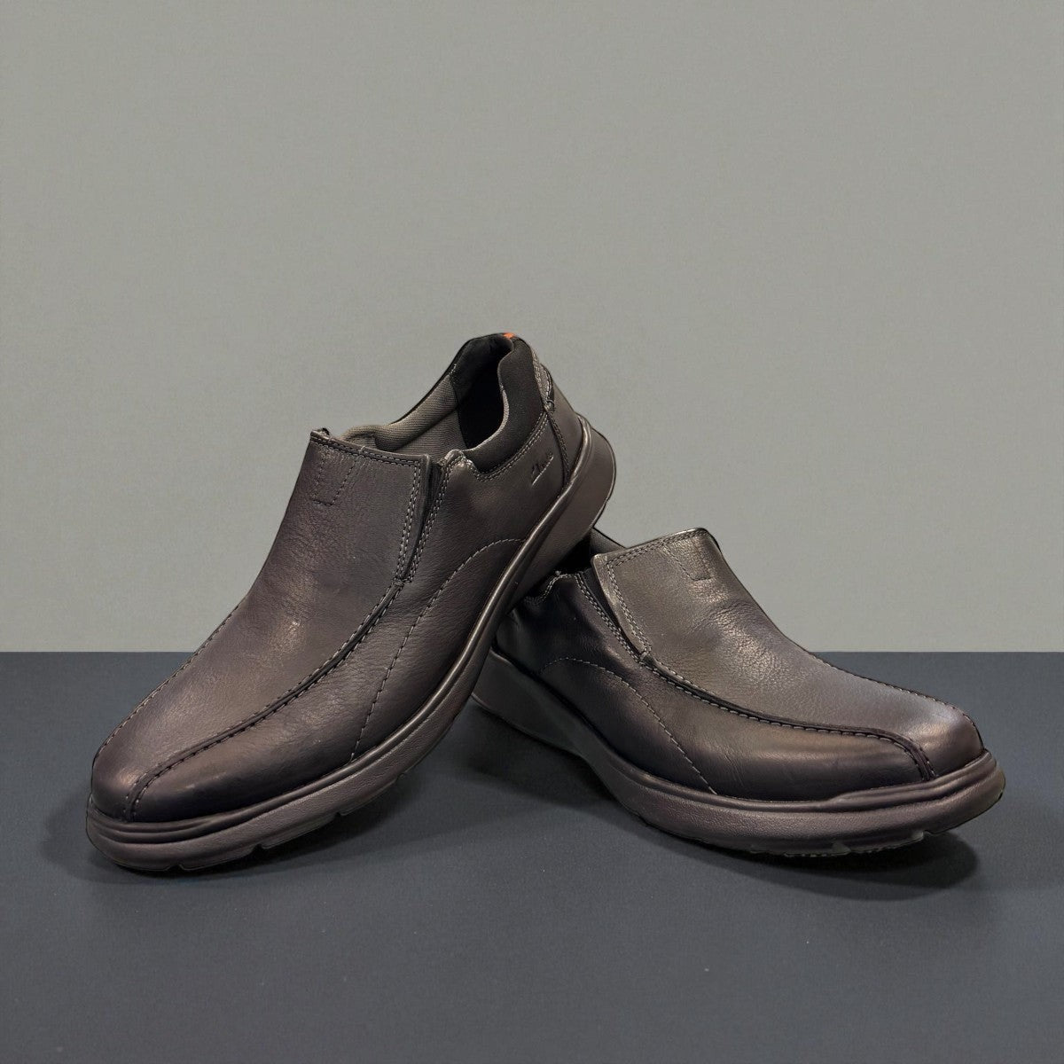Clarks Cotrell Step men's slip-on shoe in black oily leather with a shock-absorbing rubber outsole. front view