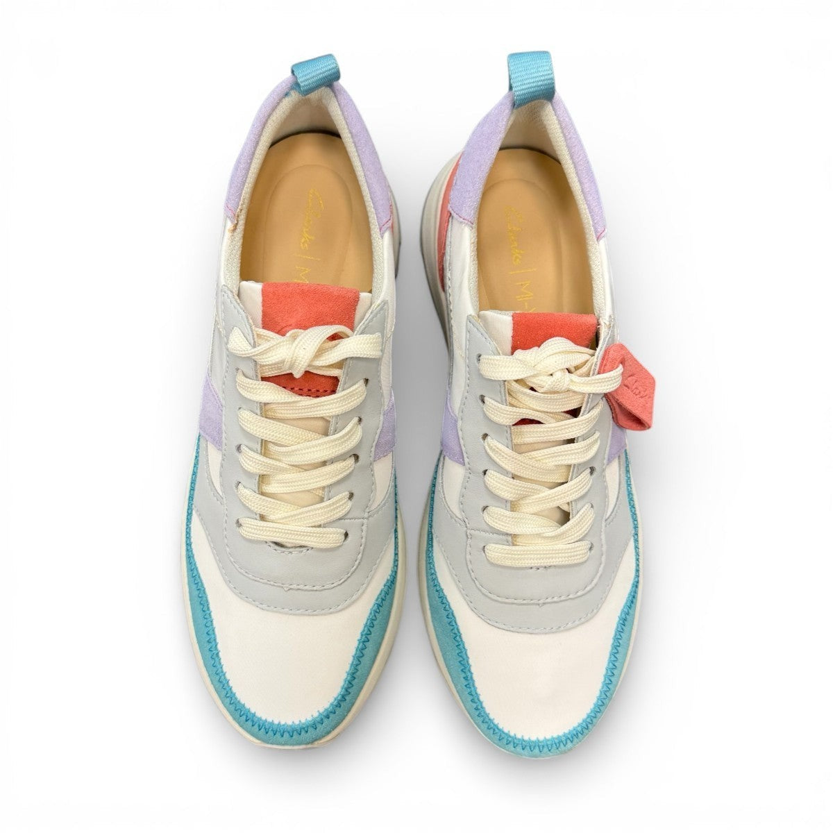 Clarks DashLite Jazz sneakers in lilac, teal, and coral leather with a retro jogger design and lace-up front. photo of the top.