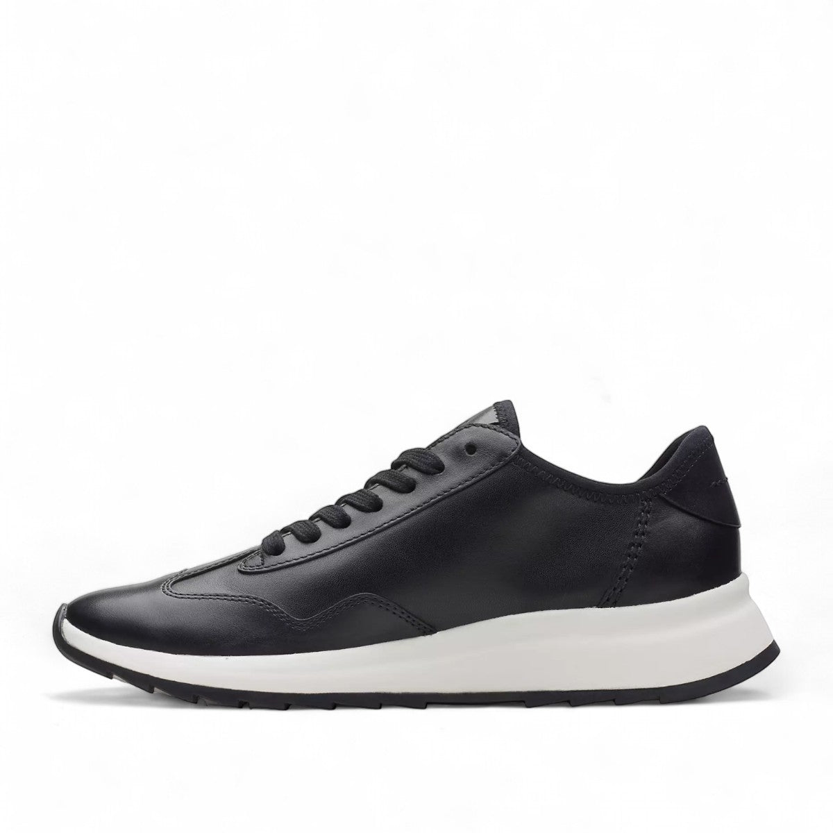 Clarks Dashlite Lo black leather sneaker with a white cushioned midsole and sporty retro silhouette.
photo of the left side.