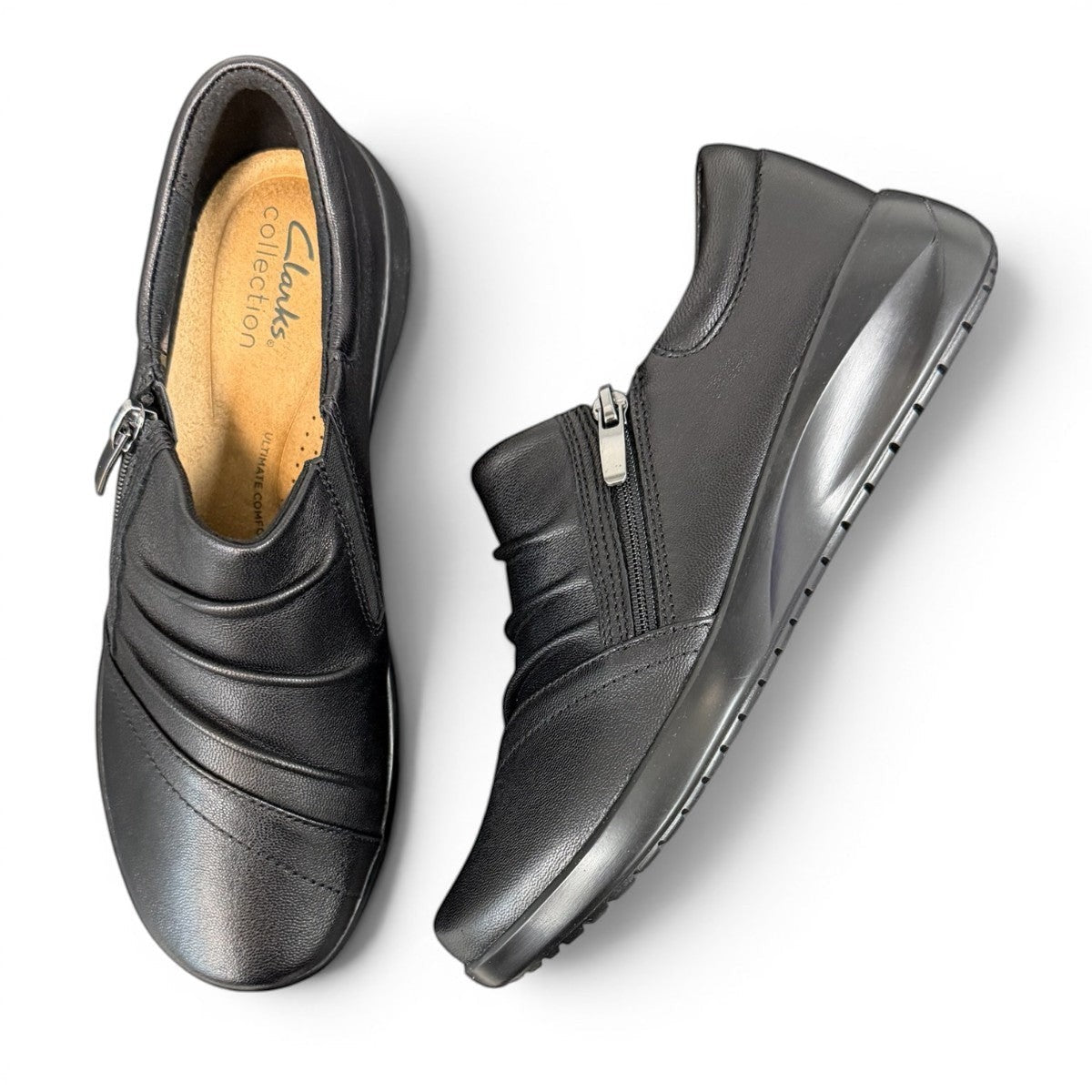 Sina Footwear Clarks Kaetlyn Mila black leather slip-on shoe with side zip and comfortable foam footbed. photo of the top.