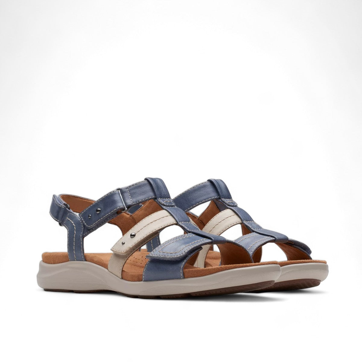 Clarks Kitly Step sandals in blue and cream leather with adjustable straps and cushioned footbed. front view.