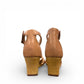 Clarks Kyarra Joy warm beige leather wedge sandal with ankle strap and woven jute heel. back view.