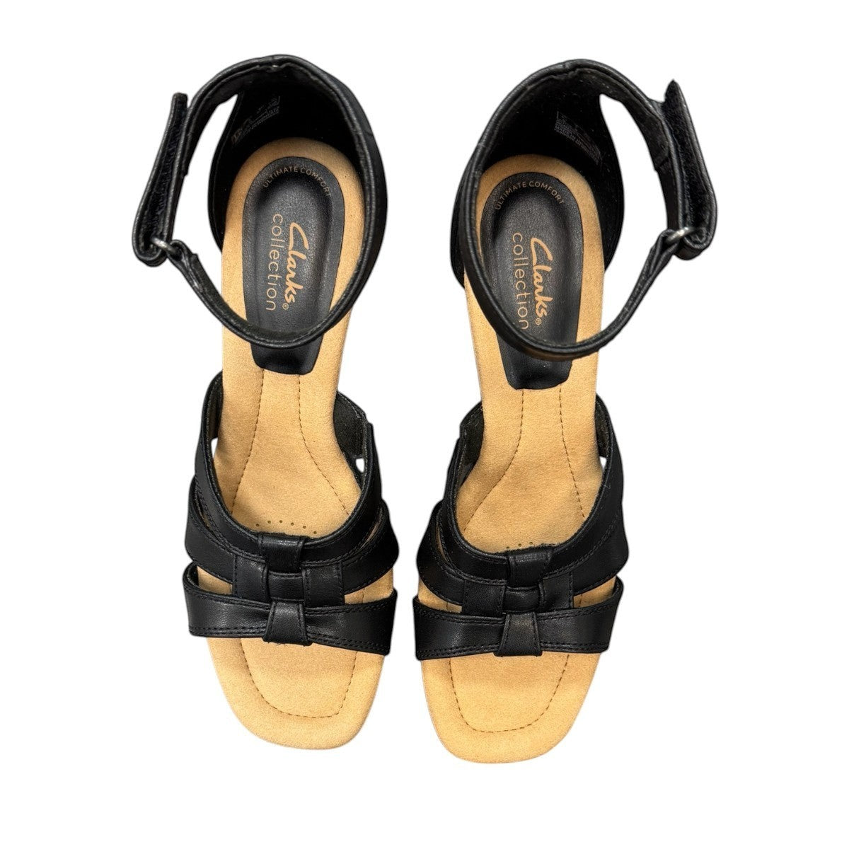Clarks Kyarra Joy black leather wedge sandals with ankle strap and textured heel. top view.