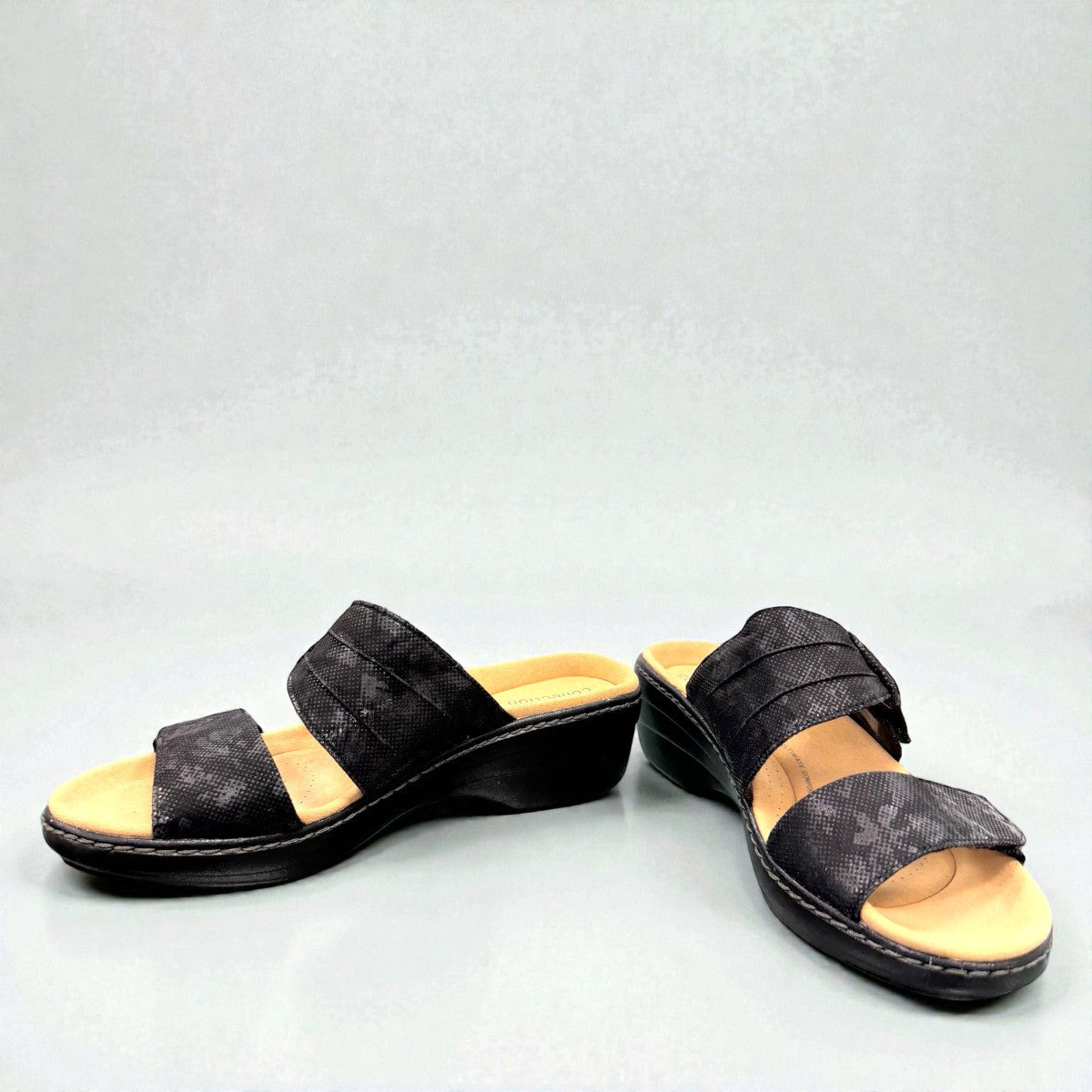 Clarks Merliah Charm black slide sandal with textile upper, and cushioned EVA sole. front view.
