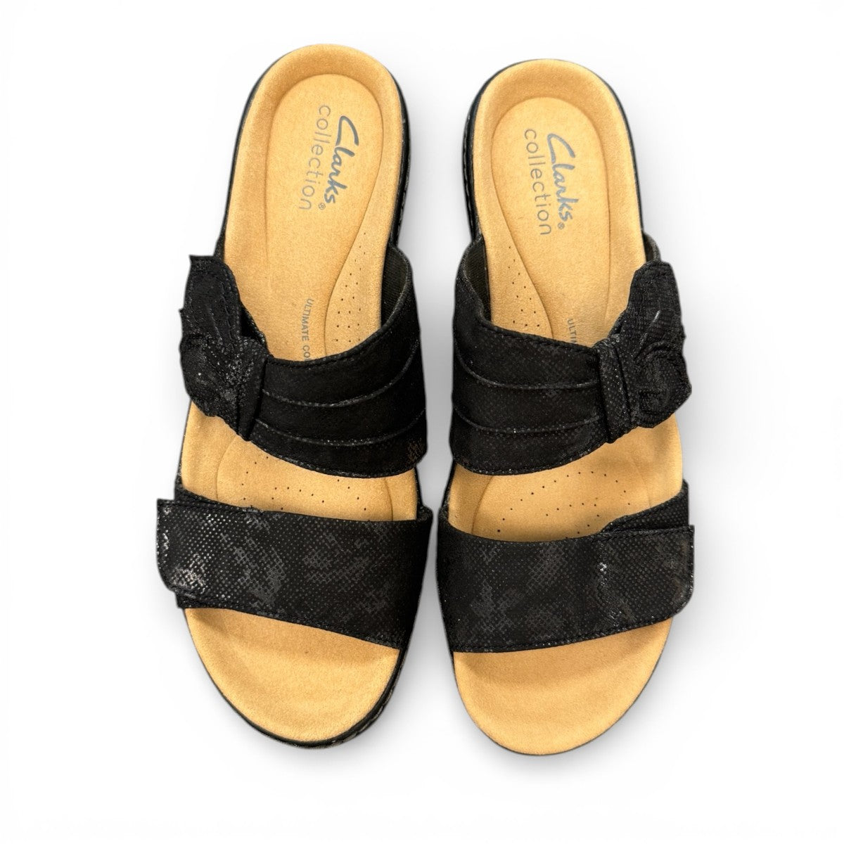Clarks Merliah Charm black slide sandal with textile upper, and cushioned EVA sole. top view.
