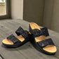 Clarks Merliah Charm black slide sandal with textile upper, and cushioned EVA sole. front view.