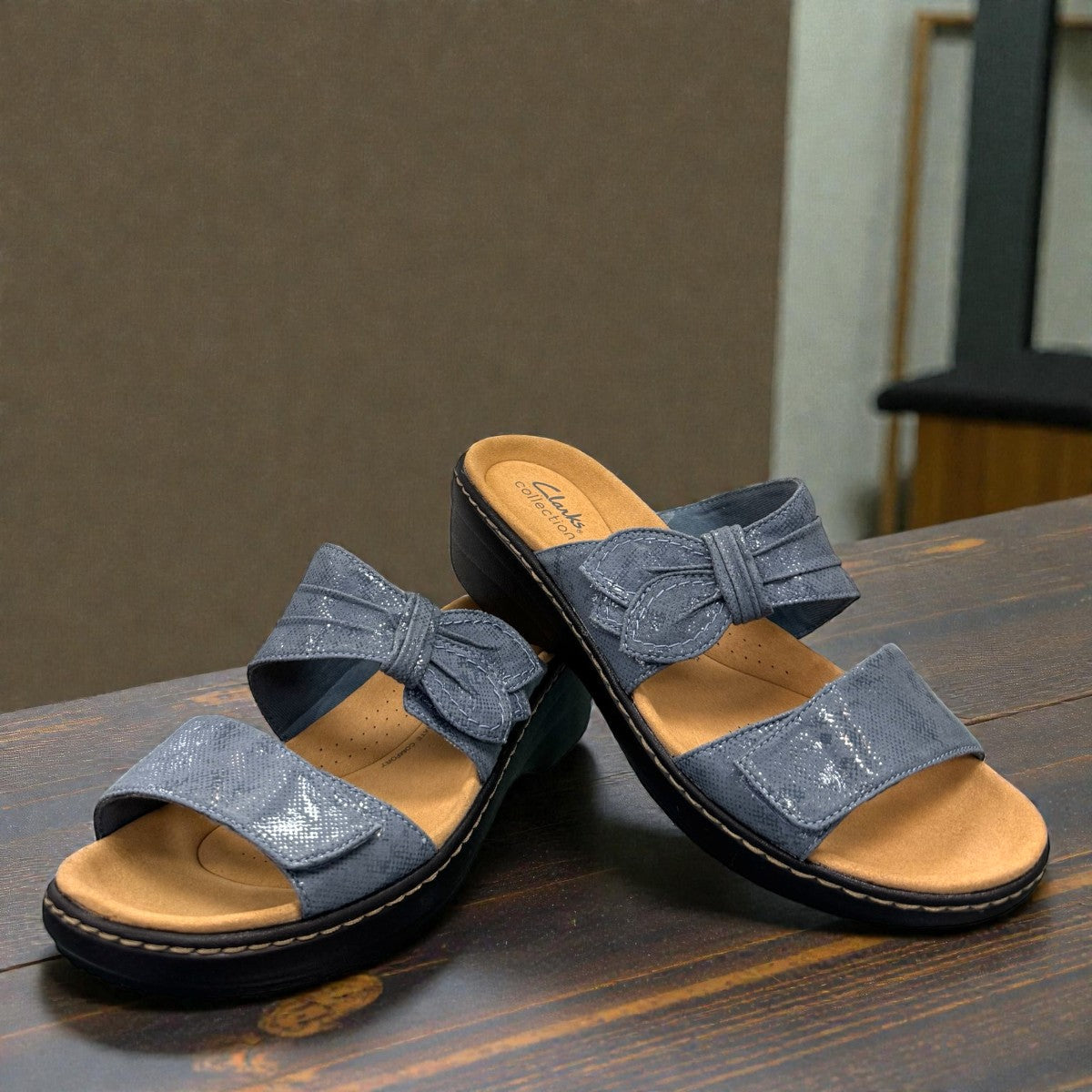 Clarks Merliah Charm blue grey slide sandal with adjustable straps, and cushioned sole. front view.