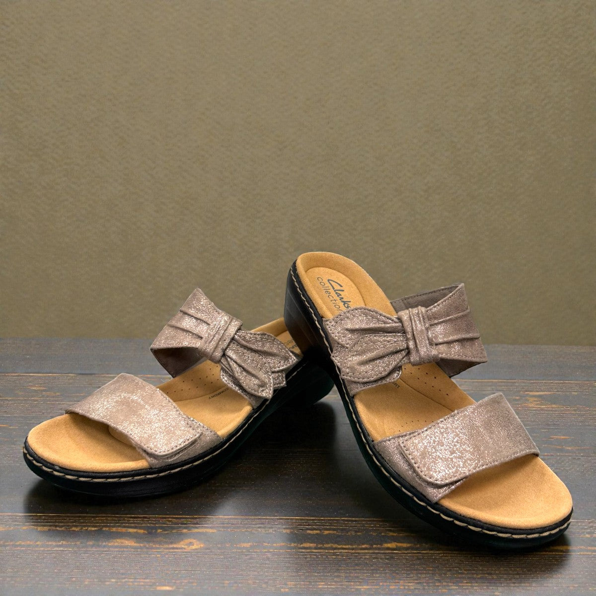 Clarks Merliah Charm taupe metallic slide sandal with adjustable grip tape closure. front view.