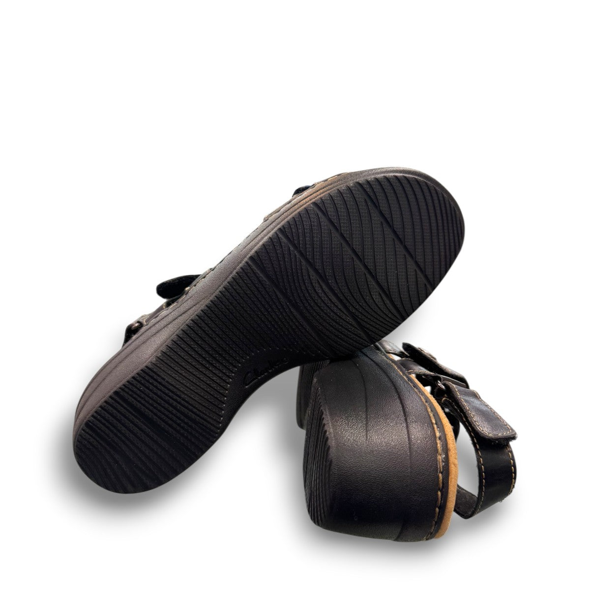 Clarks Merliah Dove black leather wedge sandals with adjustable straps and perforated detailing. bottom view.