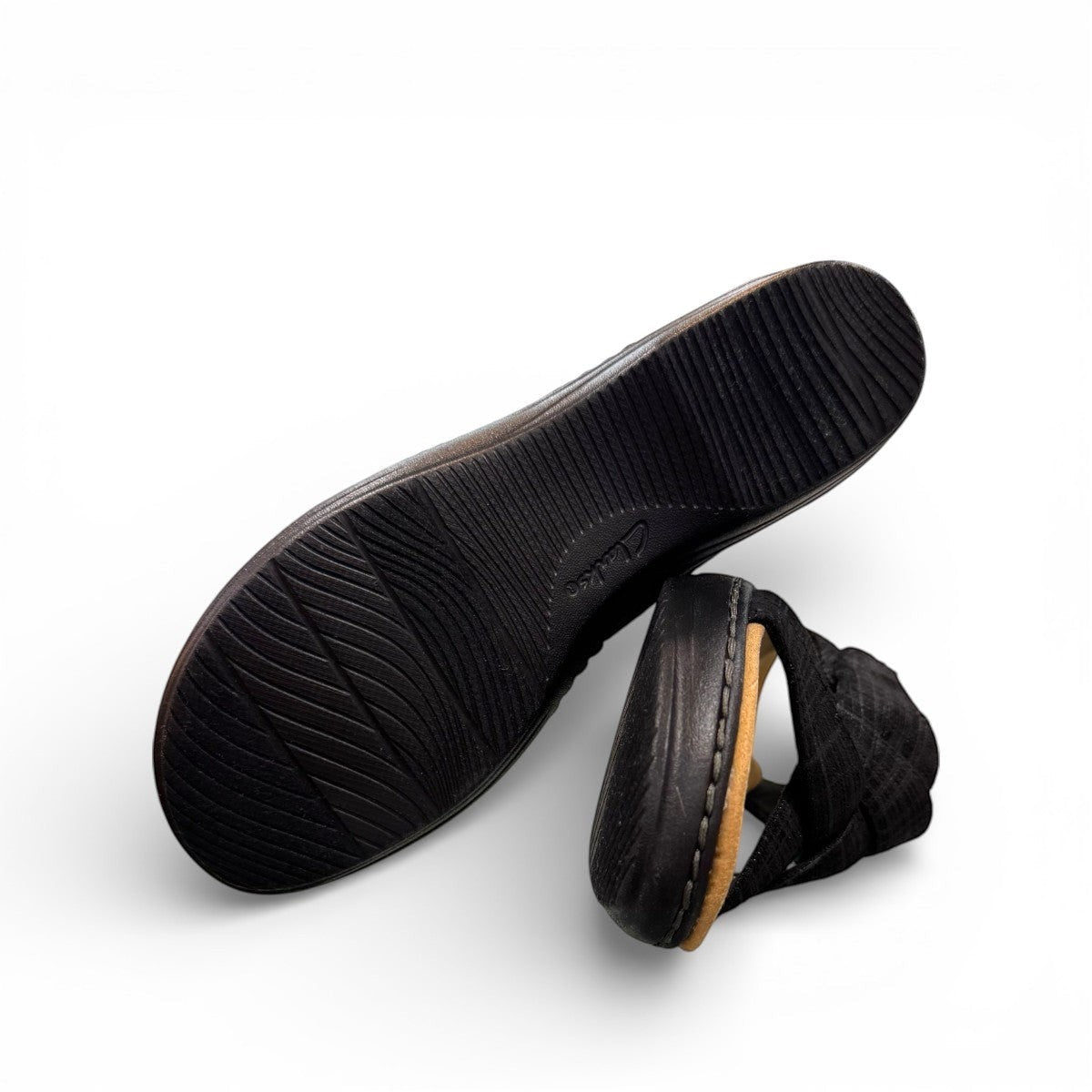 Clarks Merliah Echo black leather wedge sandal with cushioned footbed and riptape closure. bottom view.