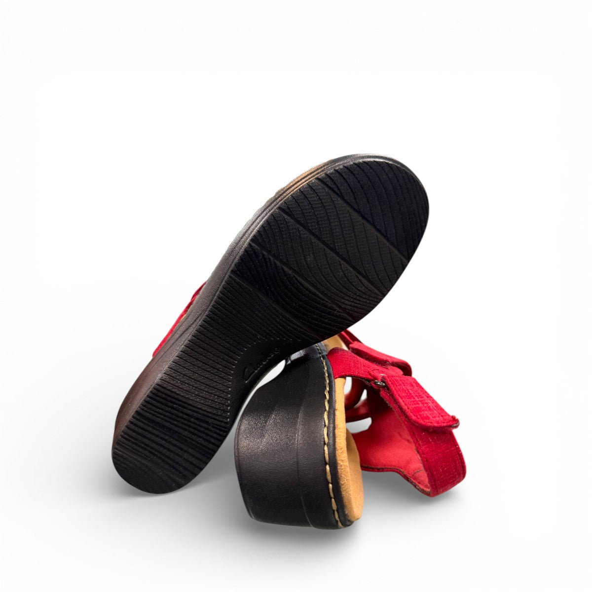 Clarks Merliah Echo red suede wedge sandals with riptape closure and cushioned footbed. bottom view.
