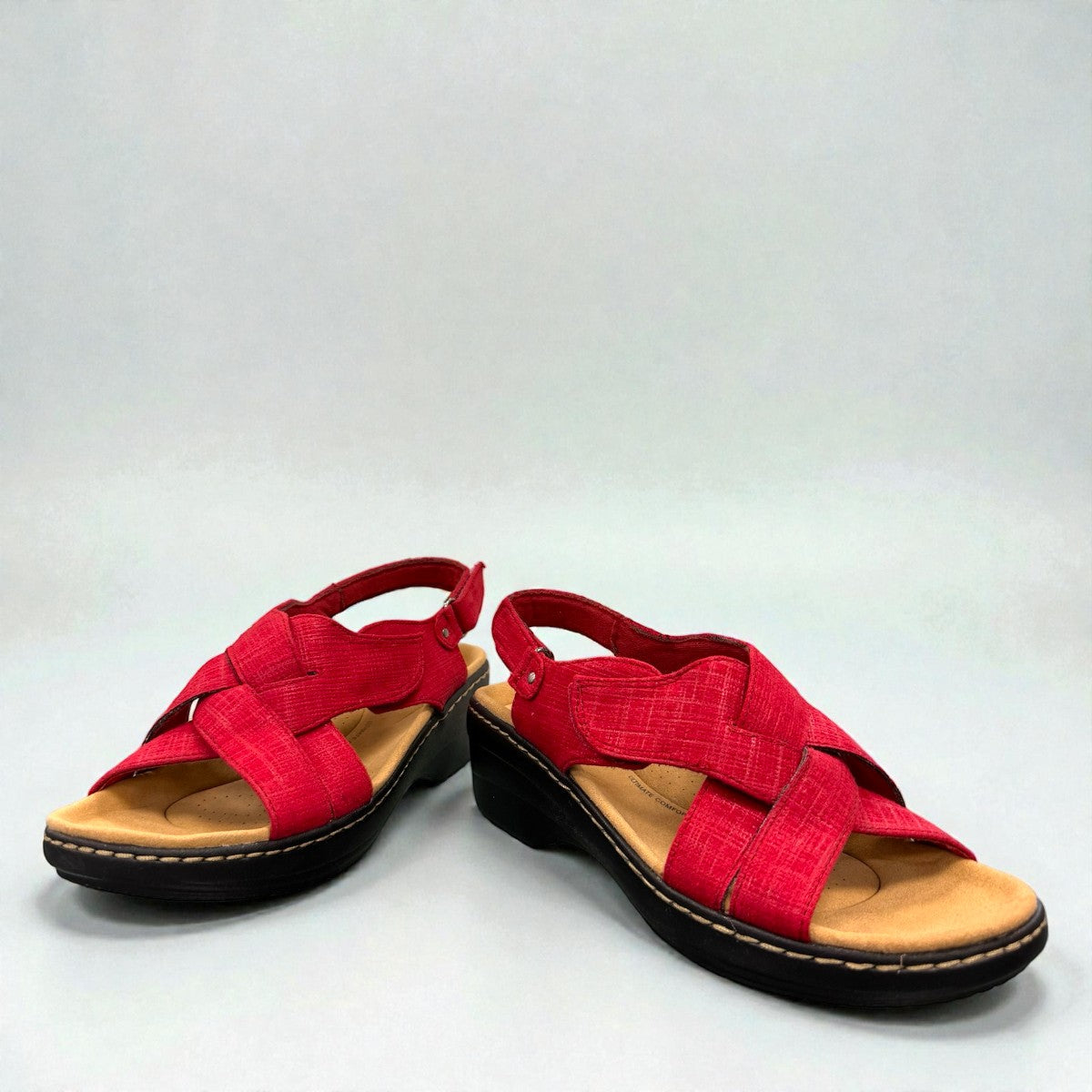 Clarks Merliah Echo red suede wedge sandals with riptape closure and cushioned footbed.front view.