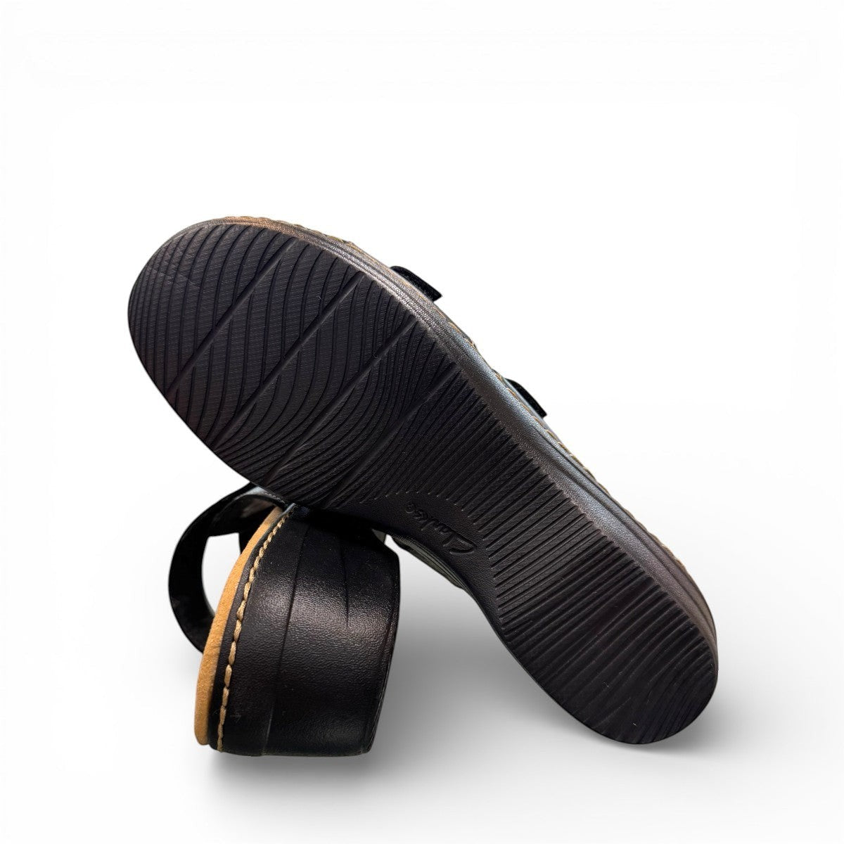 Clarks Merliah Karli black leather sandal with mid-height heel, riptape closure, and comfort footbed. bottom view.